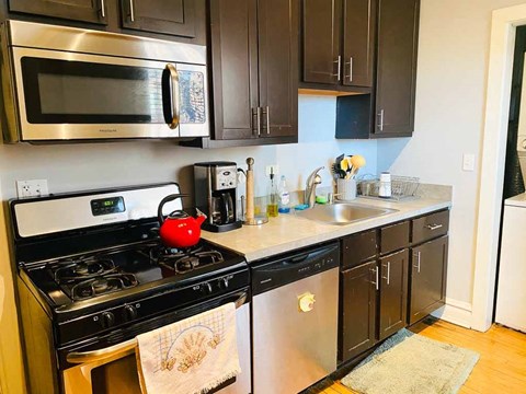 a kitchen with a stove and a sink and a microwave