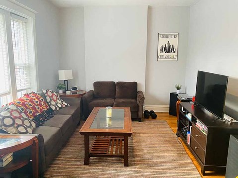 a living room with a couch and a table and a tv