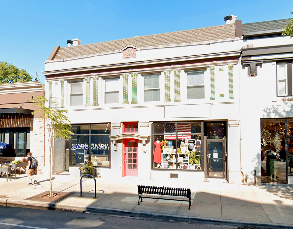 a building with a bench in front of it on a street