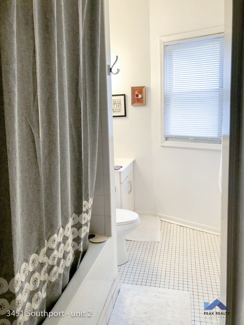 a small bathroom with a shower curtain and a toilet