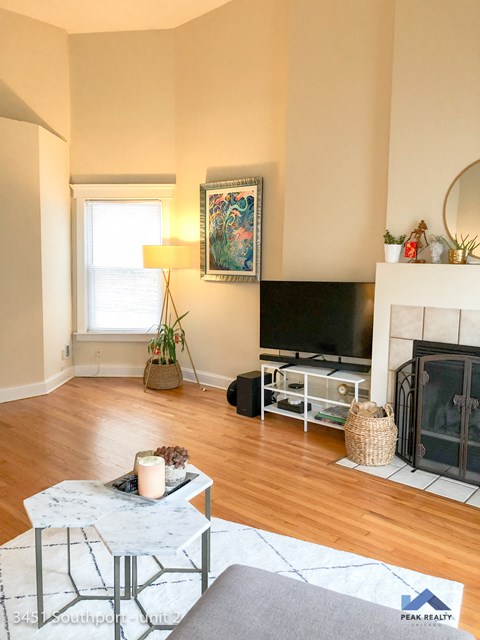 a living room with a fireplace and a television