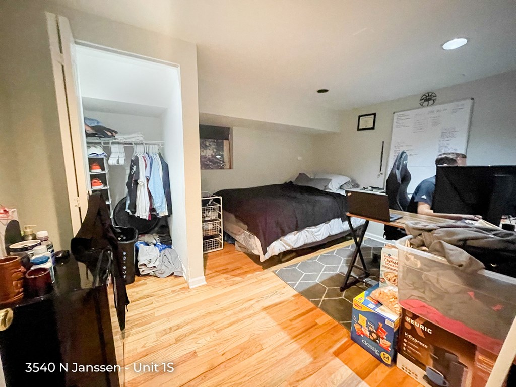 a bedroom with a bed and a desk