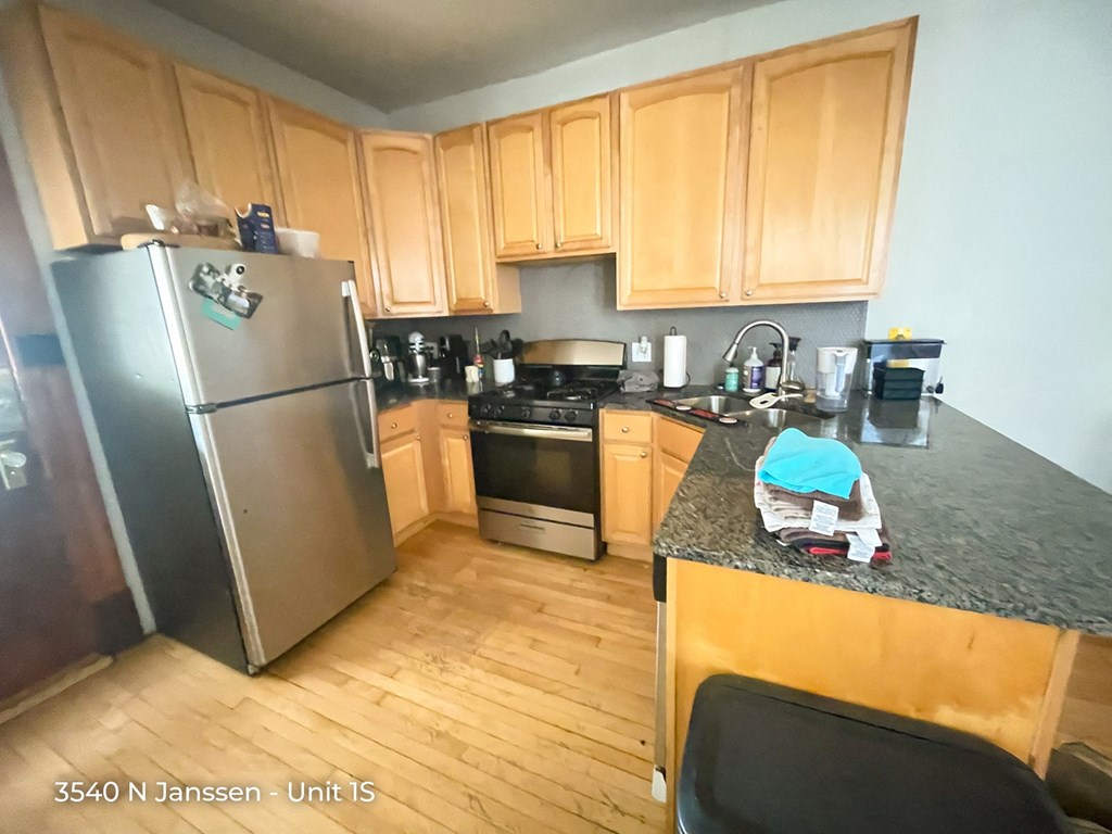 a kitchen with wooden cabinets and a granite counter top
