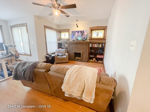 a living room with a couch and a ceiling fan