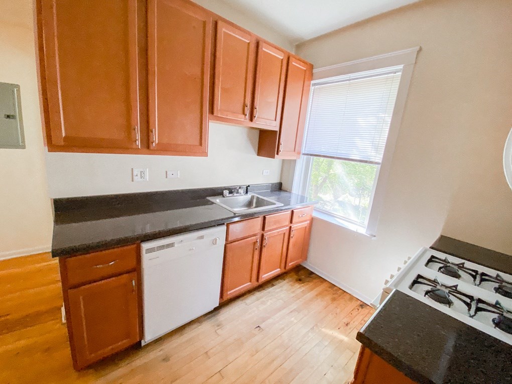a kitchen with wooden cabinets and a stove top oven