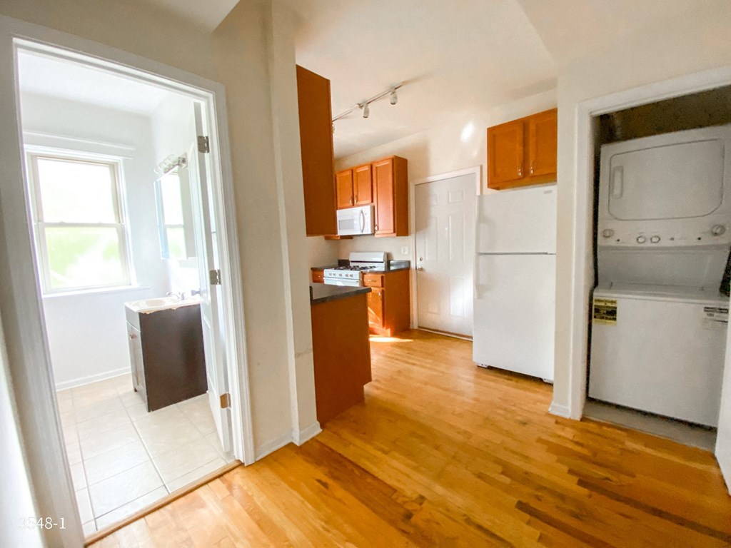 an empty kitchen with a washer and dryer