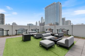 a terrace with couches and a coffee table on top of a building