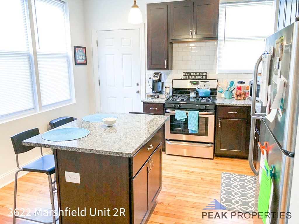 a kitchen with stainless steel appliances and a granite counter top