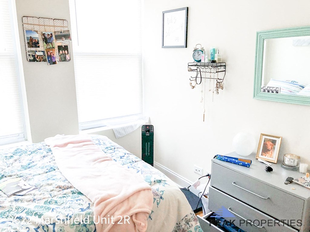 a bedroom with a bed and a dresser in it