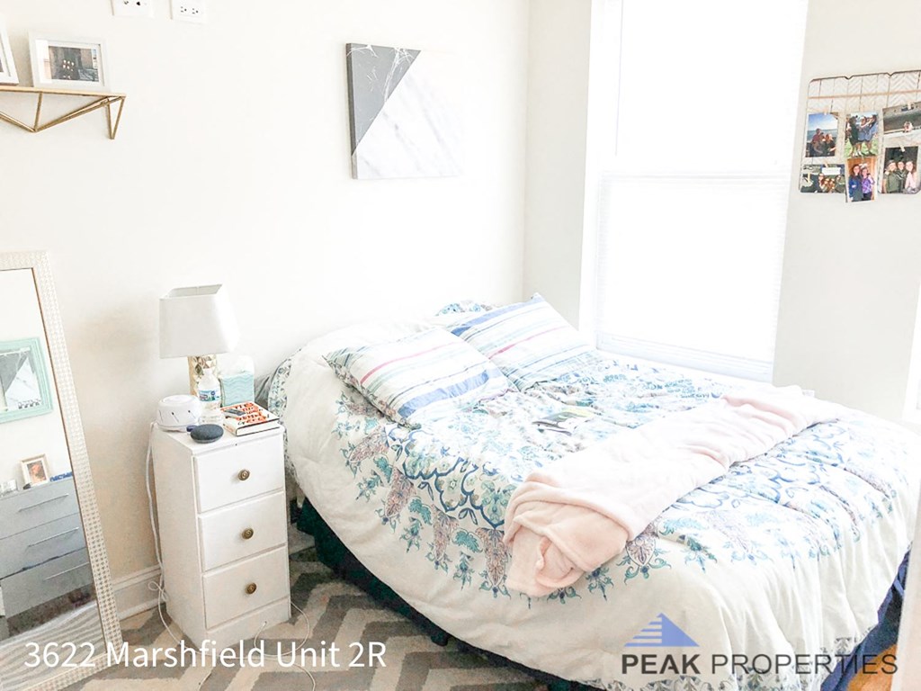 a small bedroom with a bed and a dresser