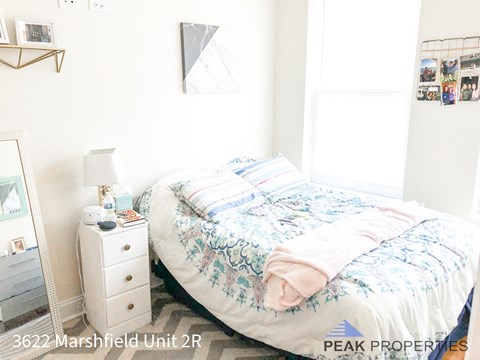 a small bedroom with a bed and a dresser