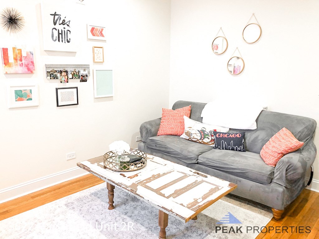 a living room with a couch and a coffee table    and a wall
