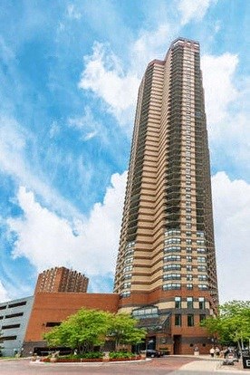 a tall building with a blue sky in the background