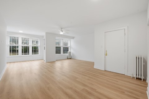 A room with wooden floors and white walls.