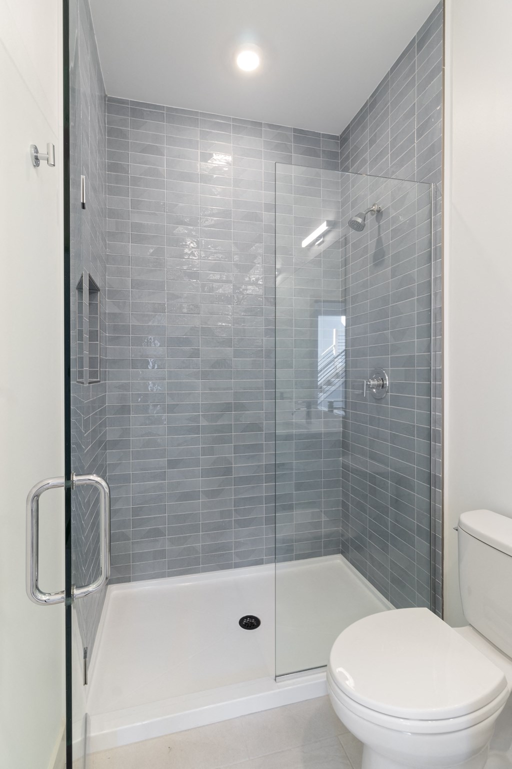 a white bathroom with a shower and a toilet