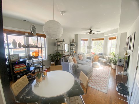 A living room with a white table and chairs.