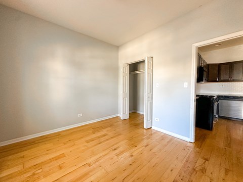 A room with wooden floors and a white door.