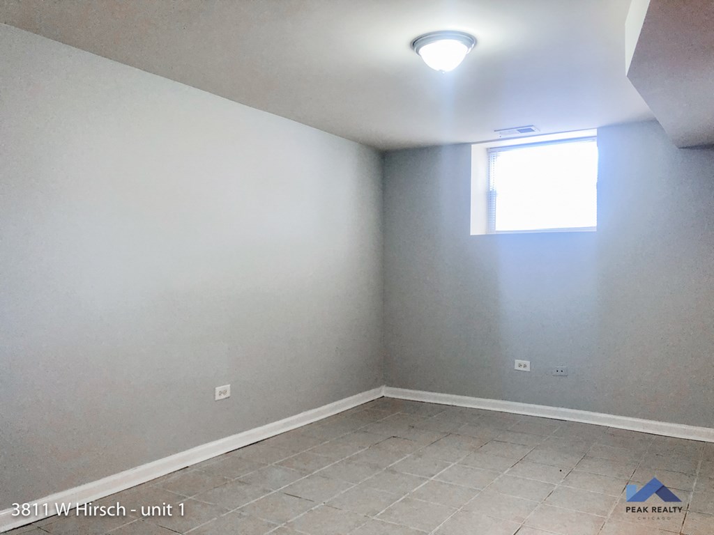 an empty room with blue and white walls and a window