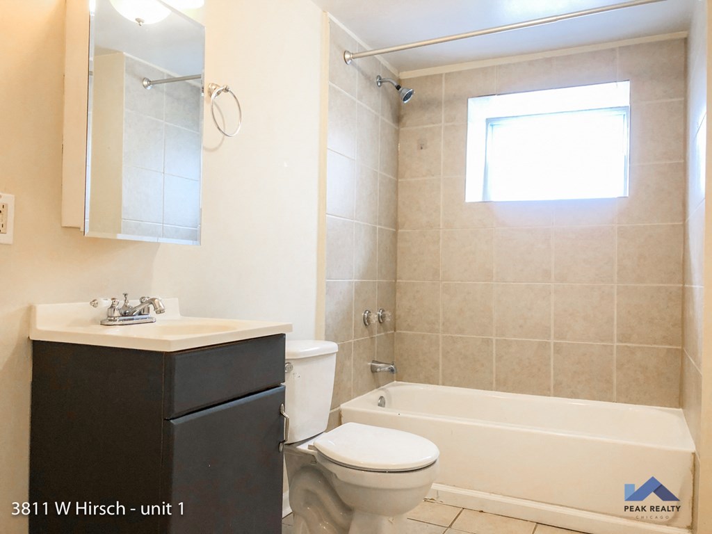 a bathroom with toilets and sinks and a shower