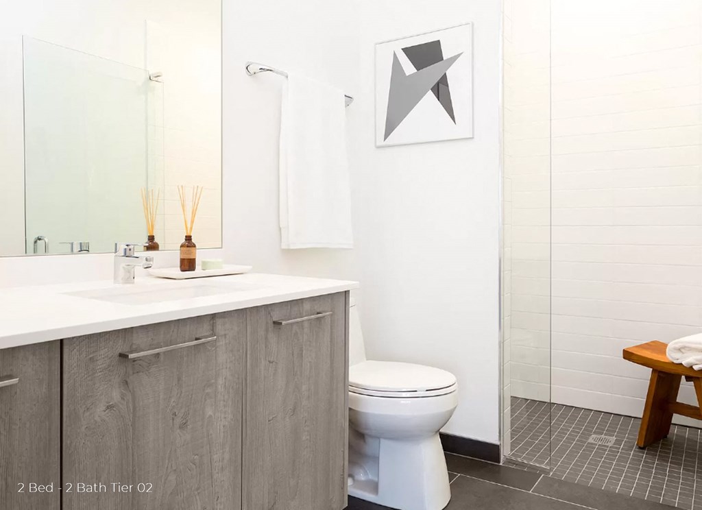 a white bathroom with a toilet and a sink