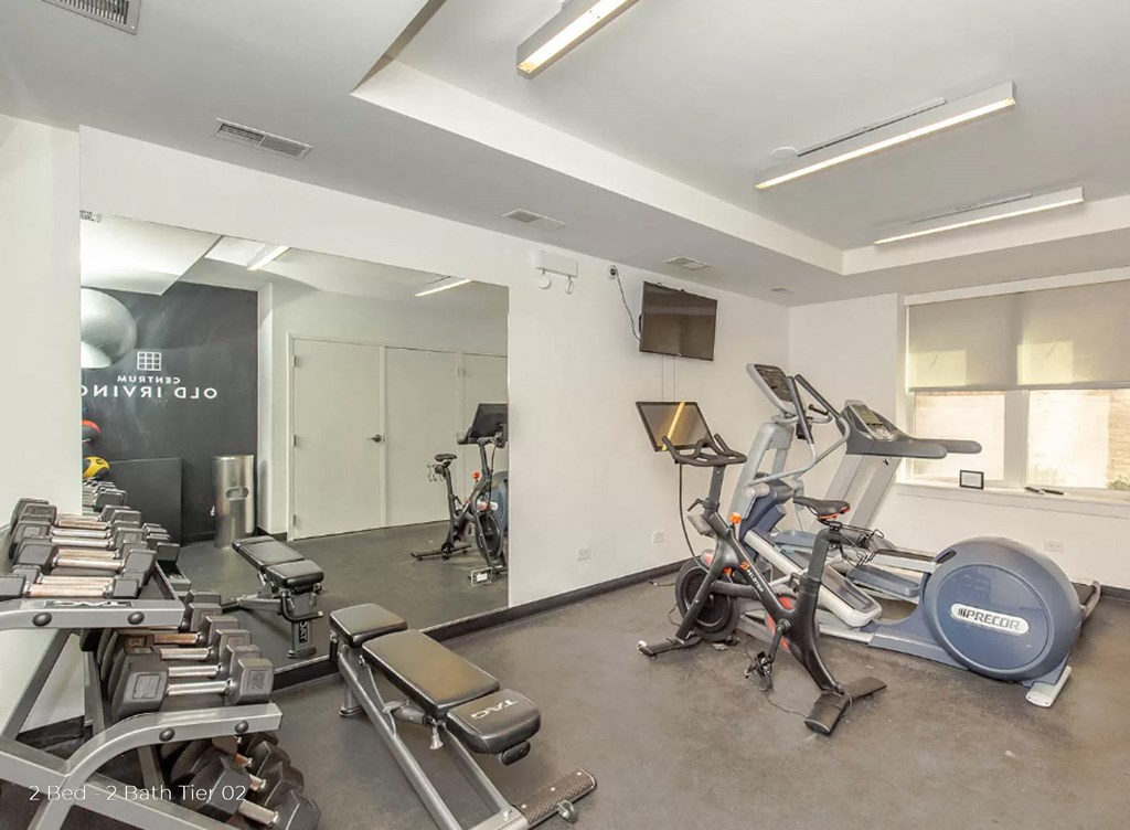 a workout room with cardio equipment and weights in a gym