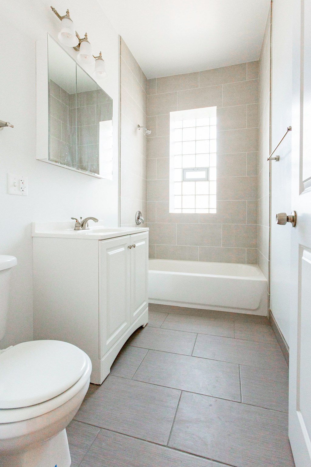 a white bathroom with a sink toilet and a tub