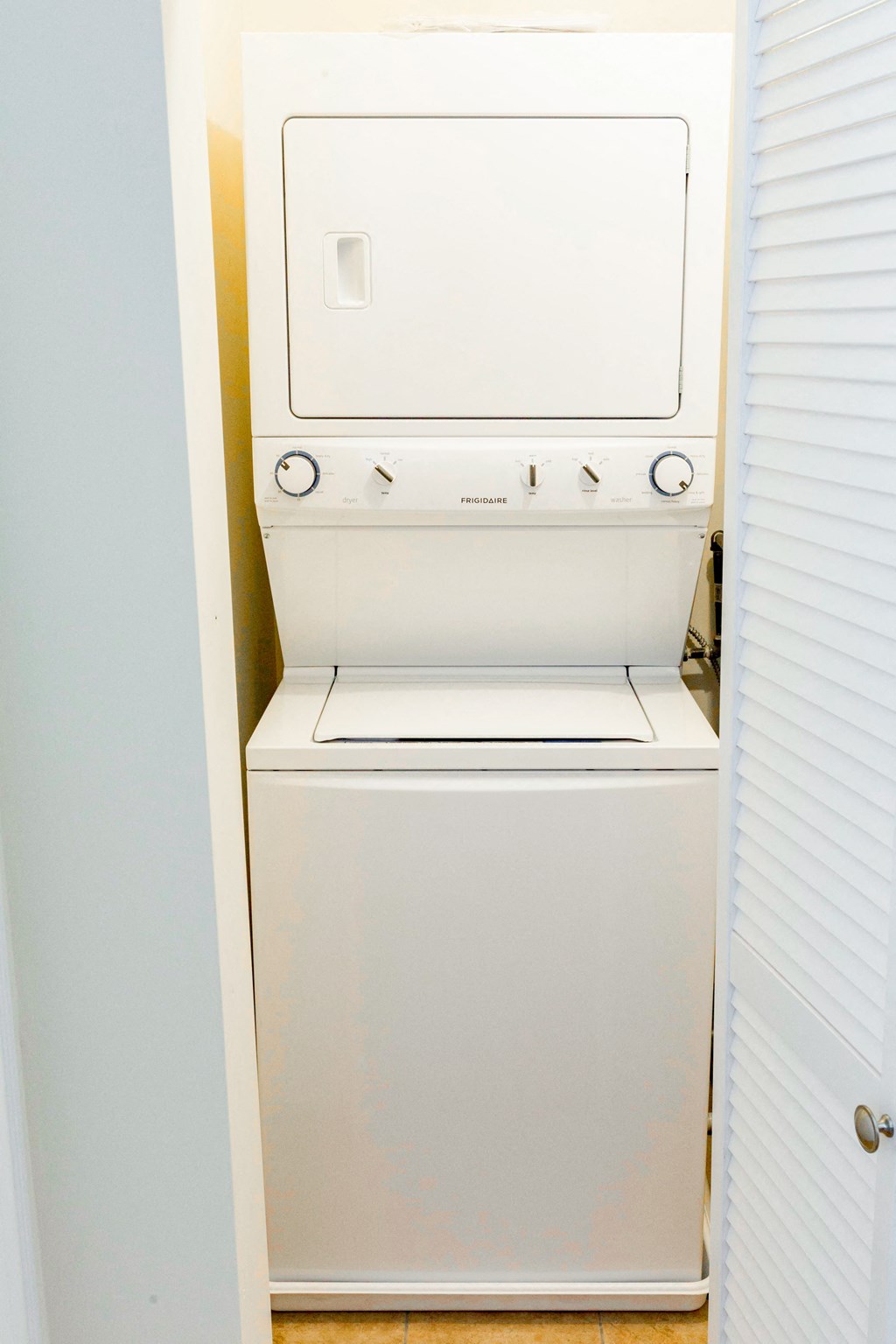a washer and dryer in a closet in a bathroom