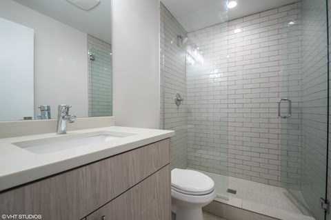 A bathroom with a white toilet and a sink.