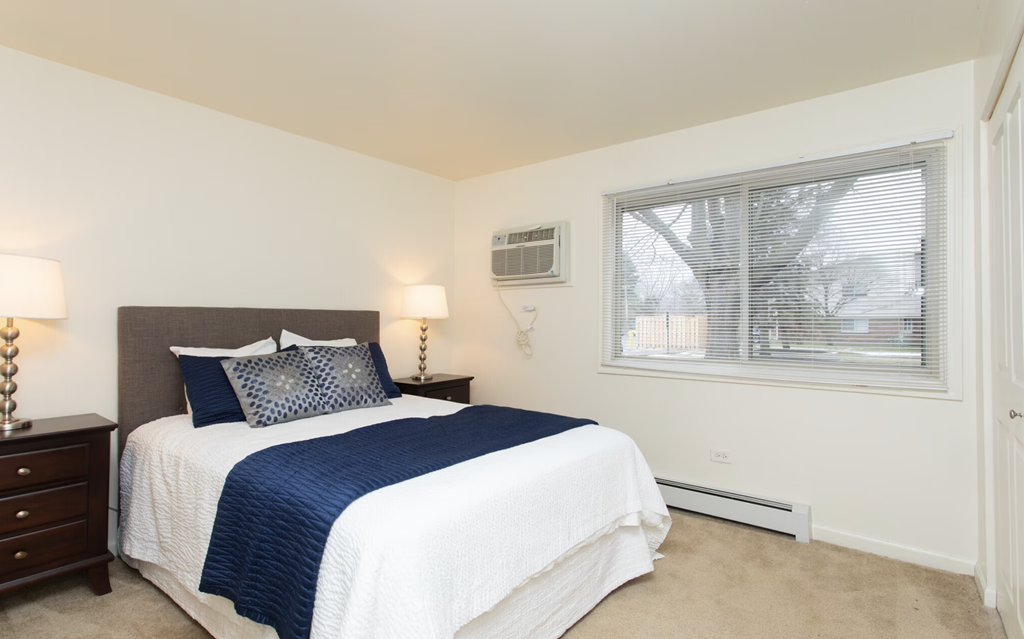 a bedroom with a bed and a window