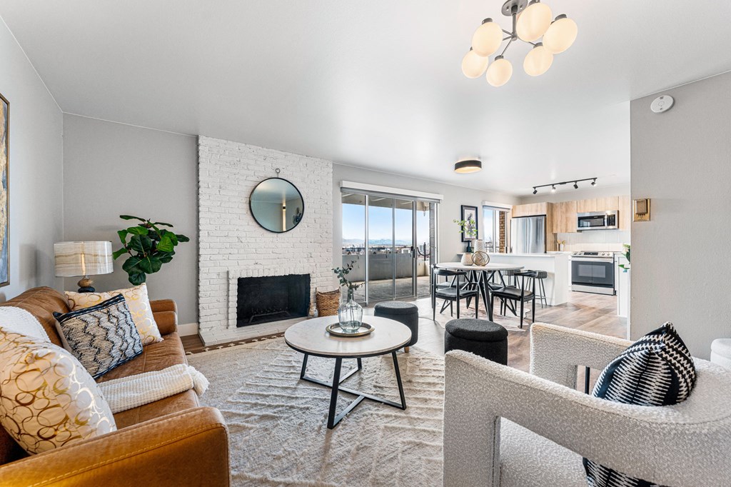 an open living room with a fireplace and a dining room table