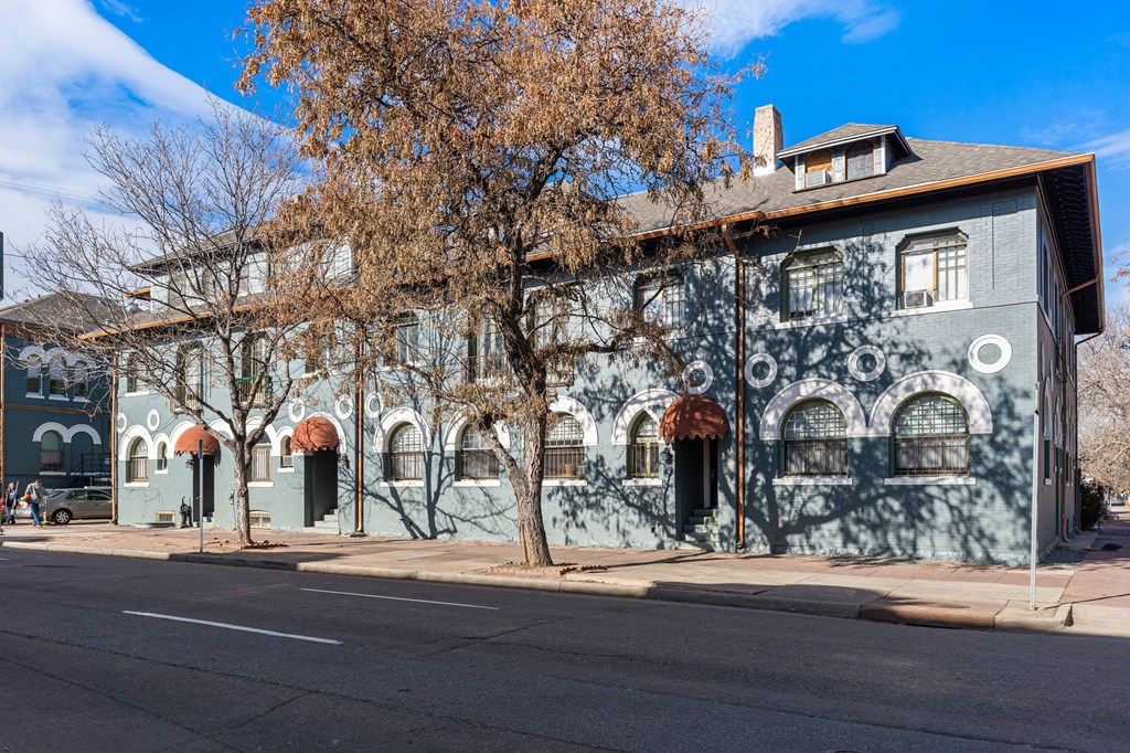 a building with graffiti on the side of a street