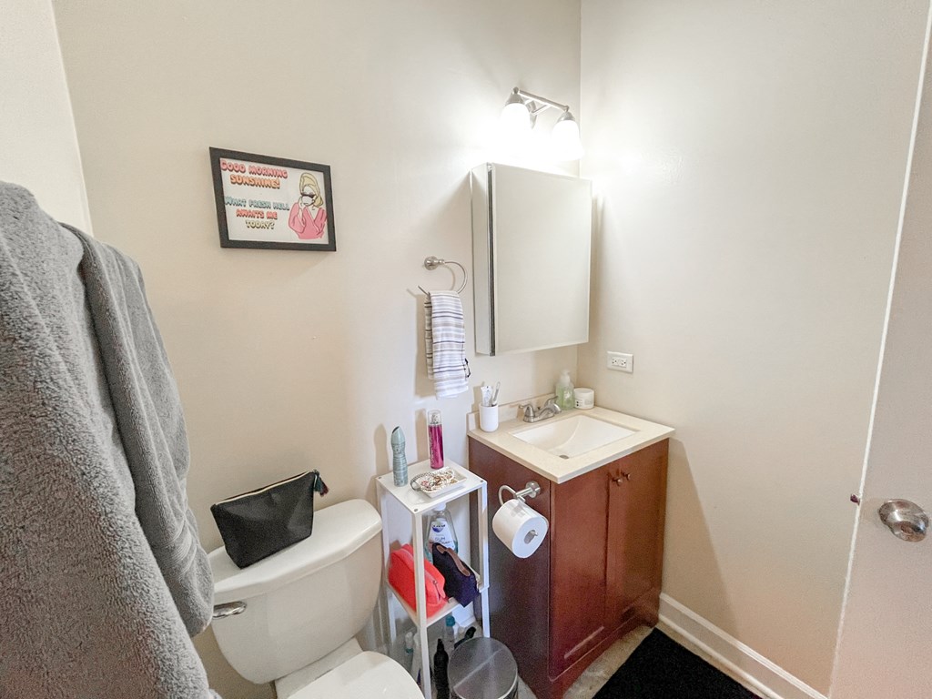 a small bathroom with a toilet sink and mirror