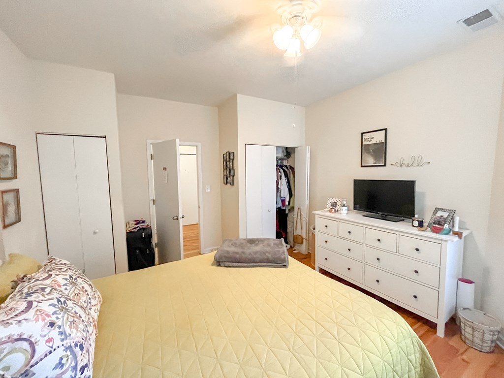 a bedroom with a large bed and a tv