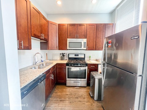 A kitchen with wooden cabinets and stainless steel appliances.