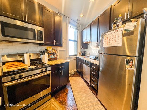 A kitchen with a stove, oven, and refrigerator.
