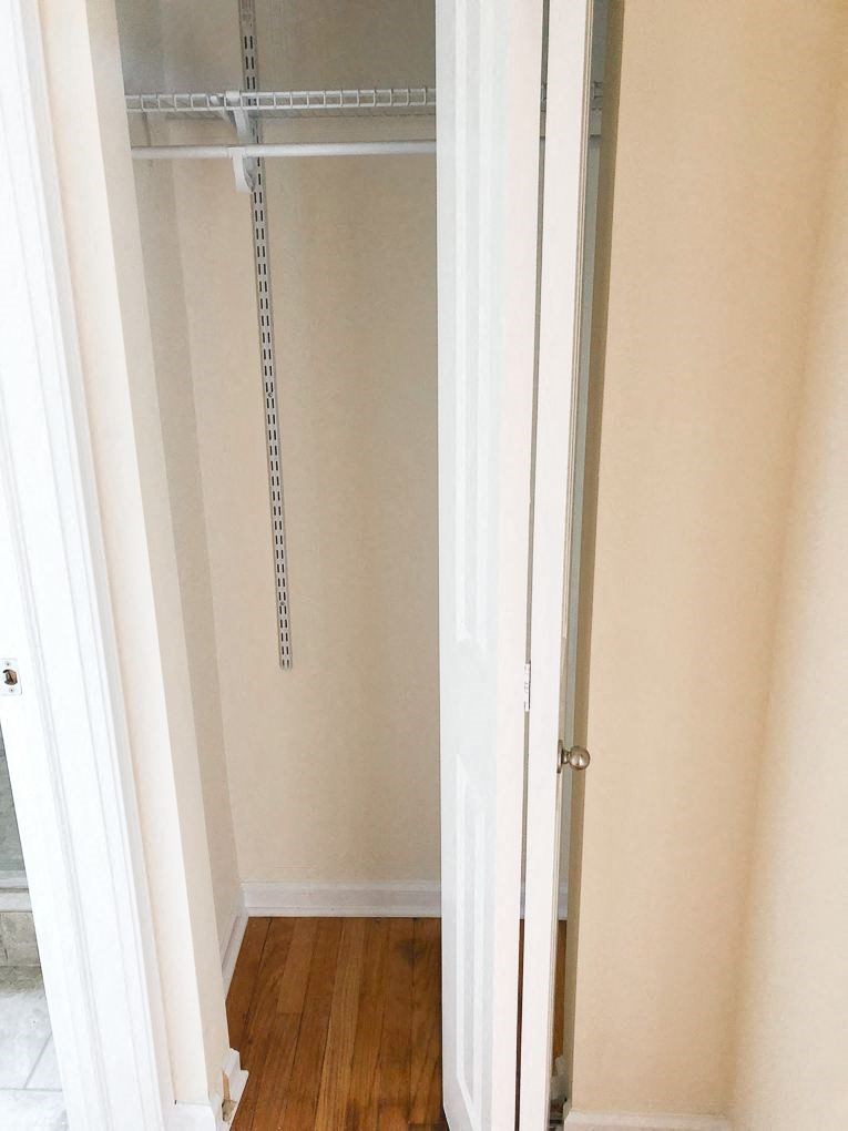 a room with a closet and a door open