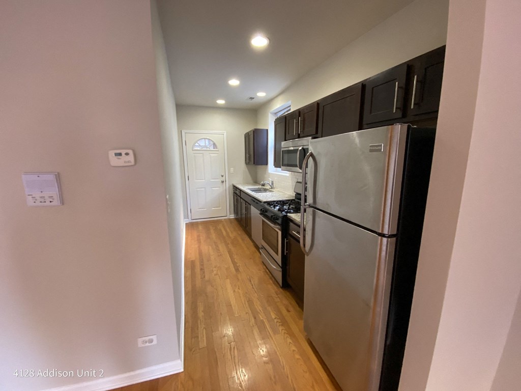 a kitchen with stainless steel appliances and black cabinets