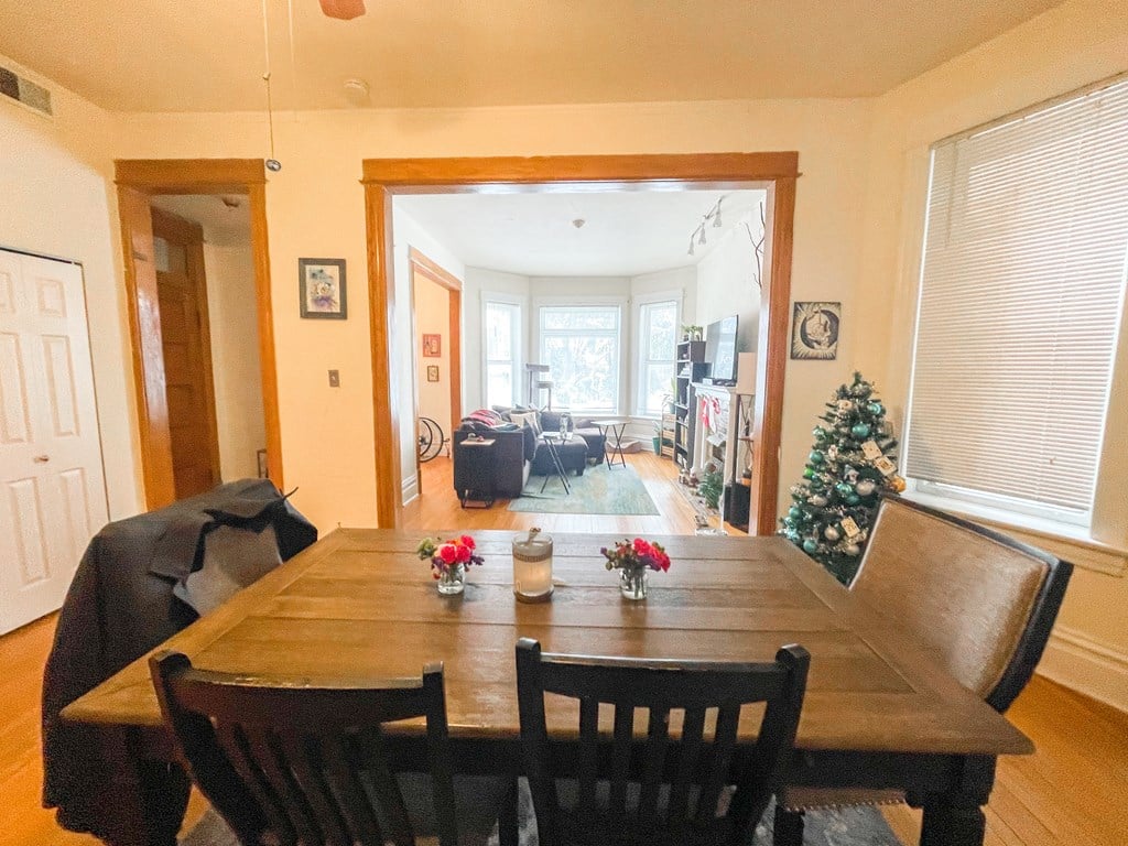 A dining room with a wooden table and chairs.