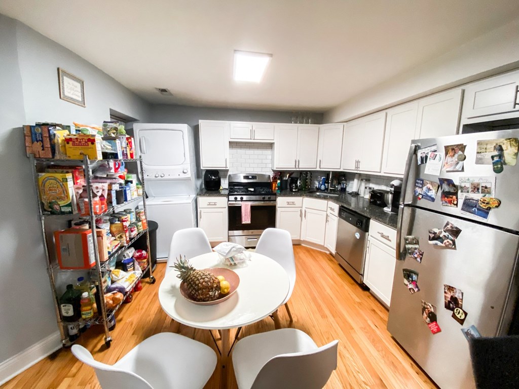 A kitchen with a table and chairs and a pineapple on the table.
