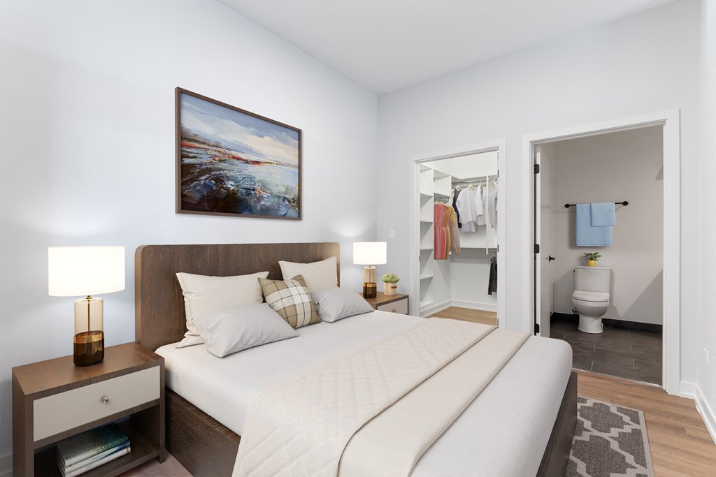 a bedroom with a large bed and two night stands with lamps