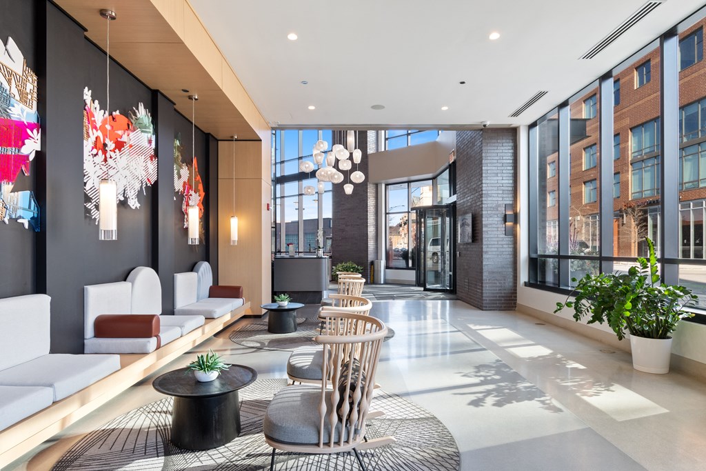 a lobby with couches and tables and a large window
