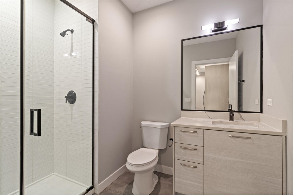 a bathroom with a shower toilet and sink