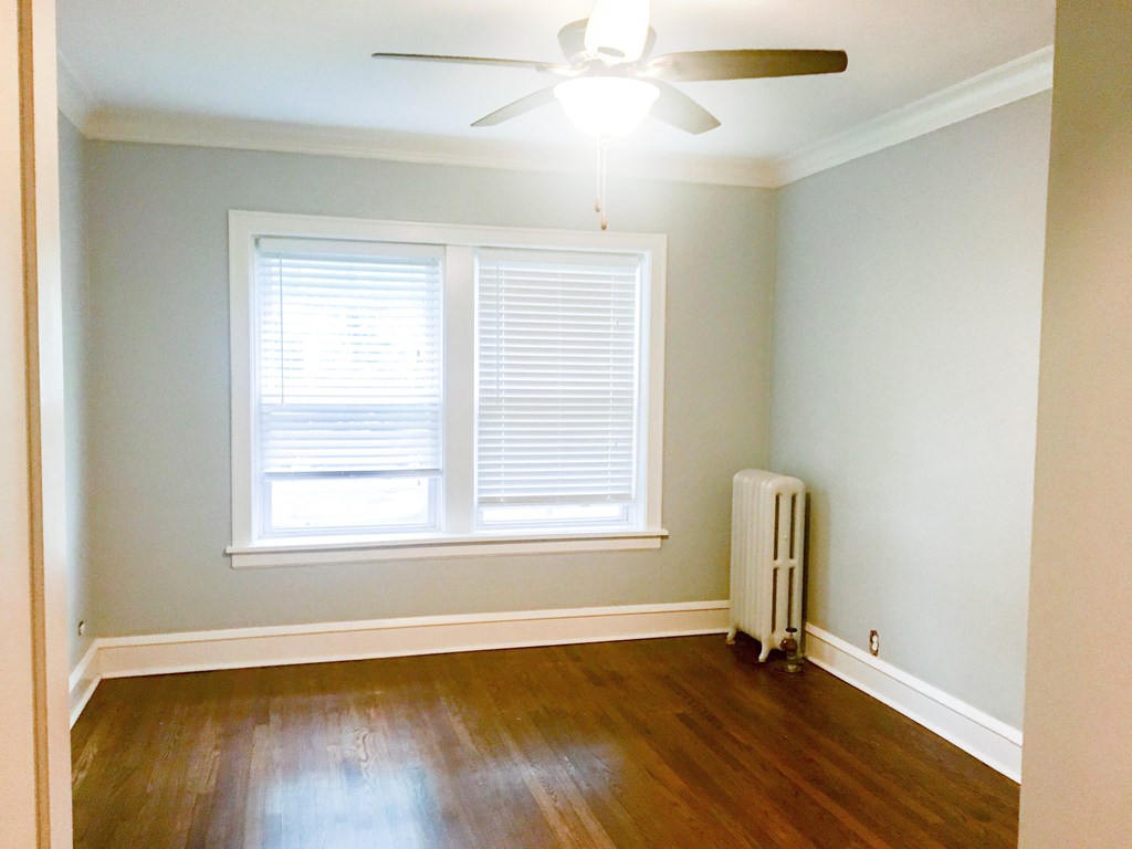 A room with a window and a fan.
