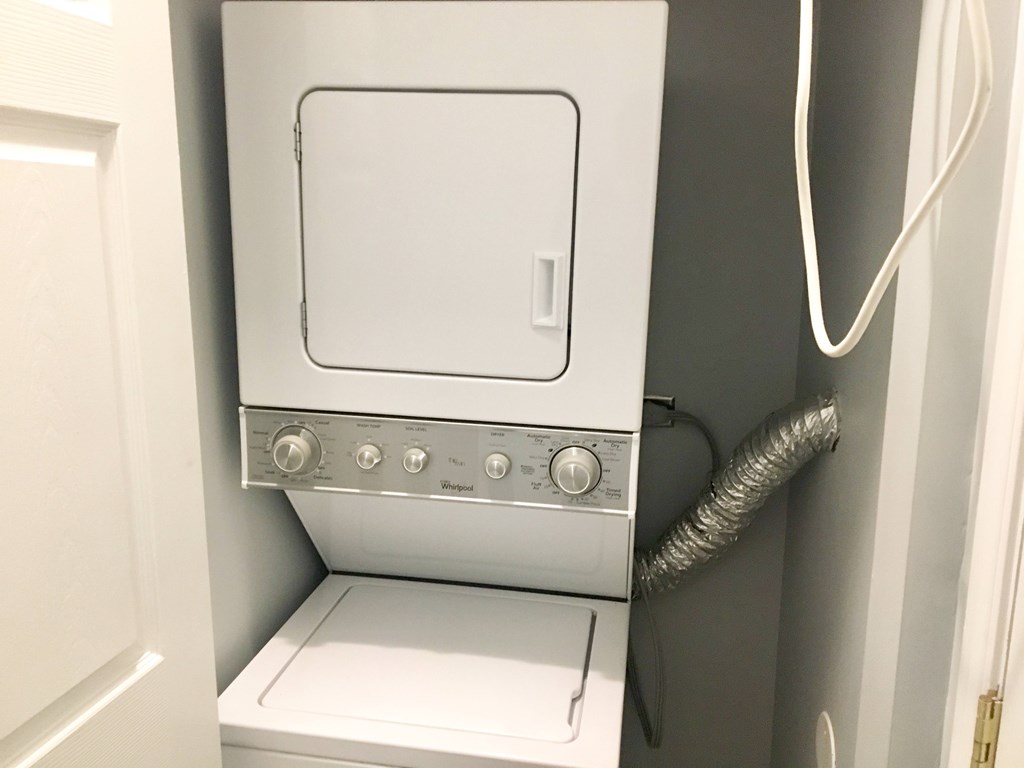 A white oven with a door and knobs on the front.