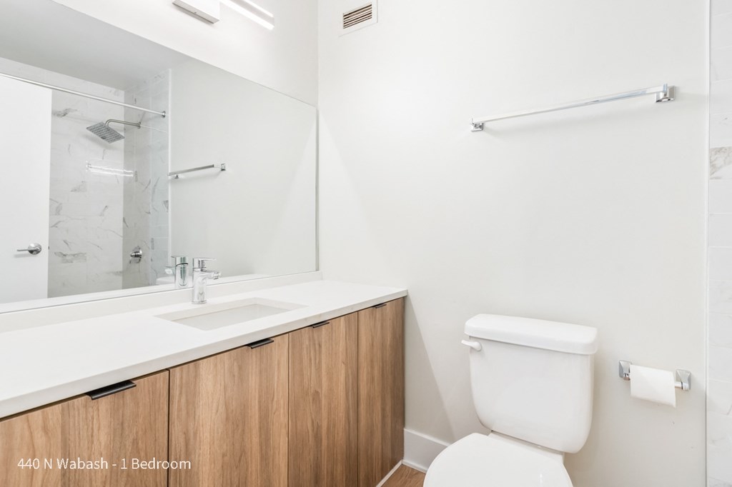 a bathroom with a sink toilet and a mirror