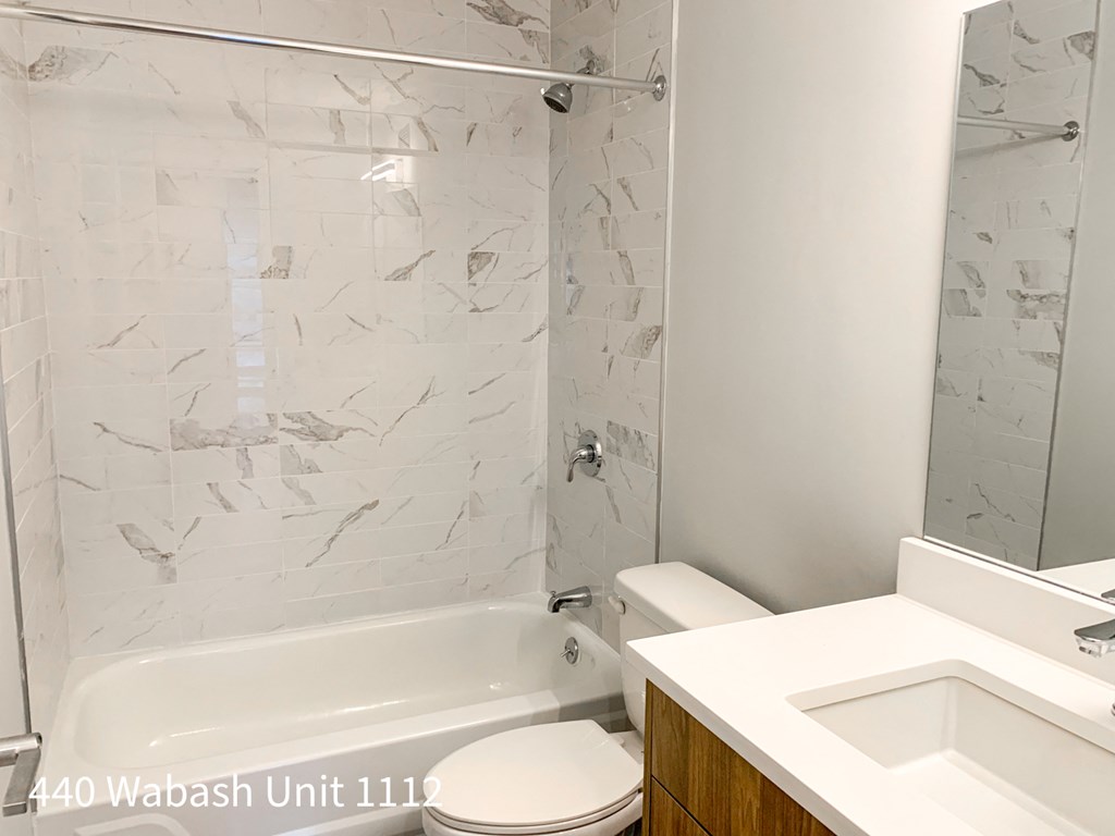 a bathroom with a shower toilet and sink