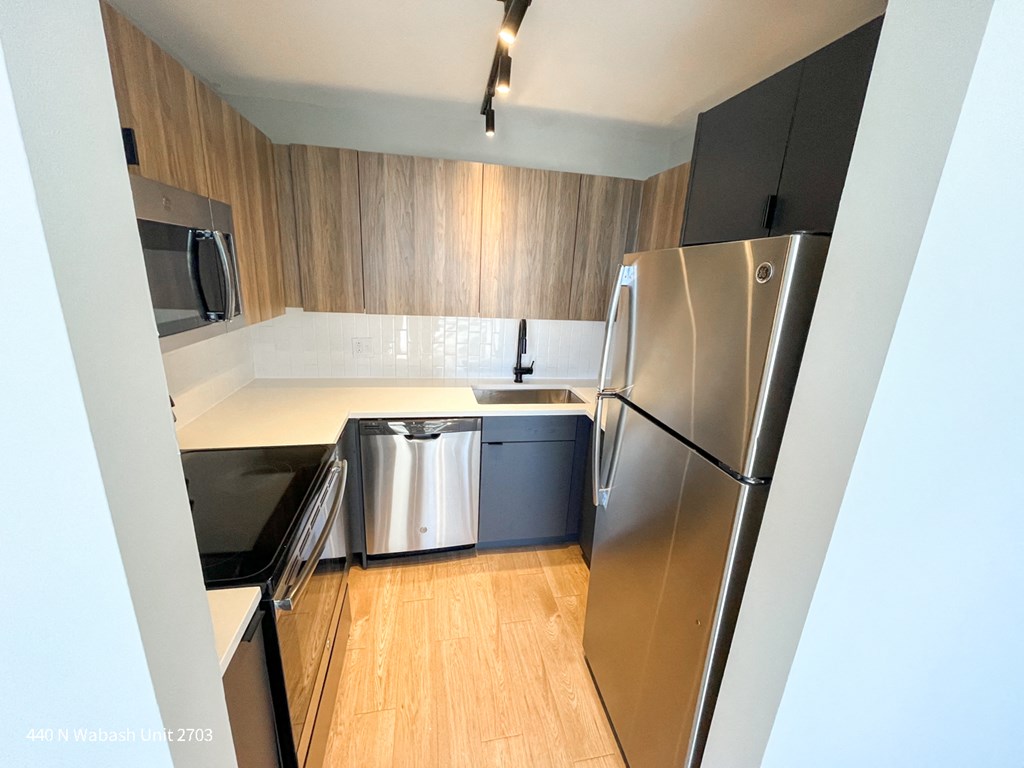 a kitchen with stainless steel appliances and wooden cabinets