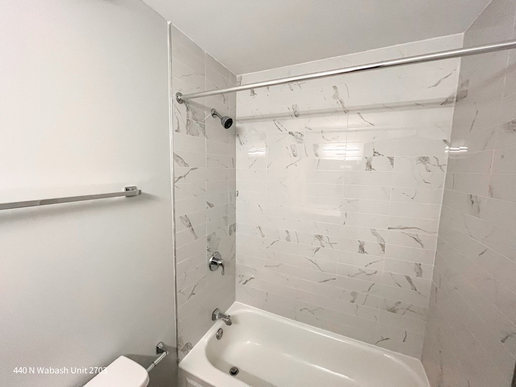 a bathroom with a tub and a sink and a shower curtain