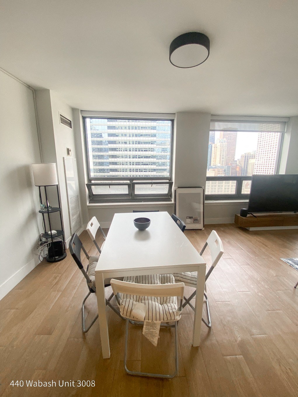 an image of a living room with a white table and chairs