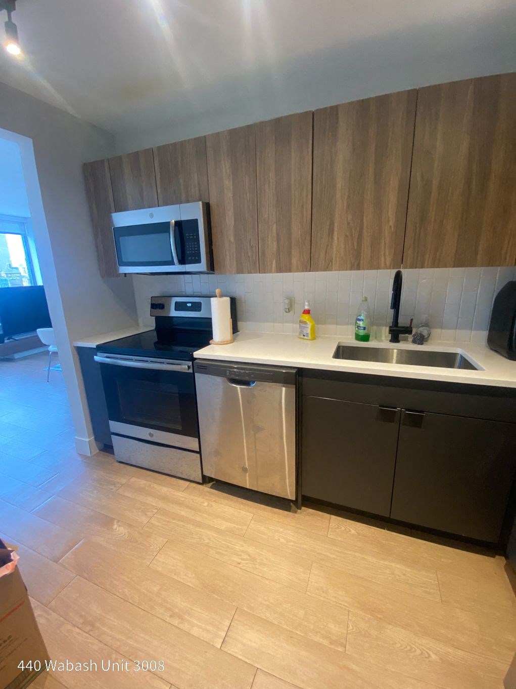 a kitchen with a sink a stove and a microwave